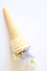 Fototapeta na wymiar Bouquet of fresh flowers in ice cream cone on white background. Happy birthday. Card. 
