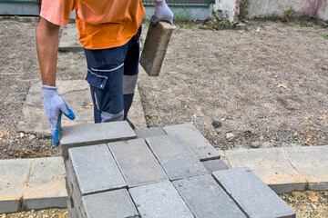 Laying concrete bricks for the sidewalk