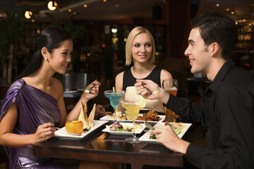 Man and women having dinner together