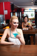 Woman drinking at a bar