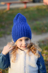 Picture of a blonde toddler girl in the funny knitted hat