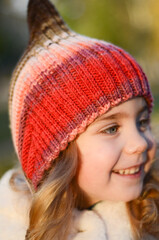 Picture of a blonde toddler girl in the funny knitted hat