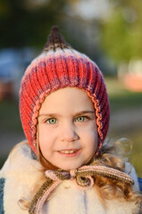 Picture of a blonde toddler girl in the funny knitted hat