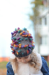 Picture of a blonde toddler girl in the funny knitted hat