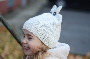 Picture of a blonde toddler girl in the funny knitted hat