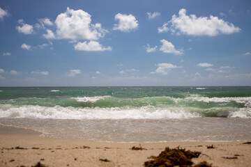 Fototapeta na wymiar waves on beautiful troical sandy sea beach with blue sky