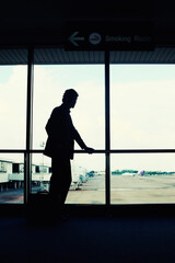 Fototapeta na wymiar Businessman waiting for his flight in airport lounge