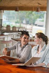 Man and woman reading menu in a restaurant