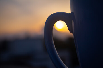 Coffee cup in open bar with evening sky background