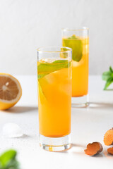 Jamu Indonesian herbal beverage with natural ingredients turmeric, ginger, lemon on white background. Close up.