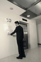Businessman pushing elevator button