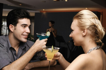 Man and woman toasting drinks