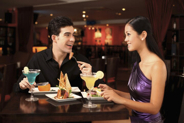 Man and woman chatting while having dinner together