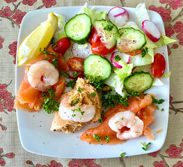 Delicious deluxe seafood salad of fresh crab, smoked salmon and prawns with salad greens