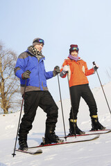 Man and woman skiing