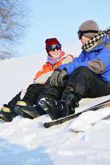 Fototapeta na wymiar Man and woman relaxing after skiing