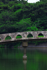 Fototapeta na wymiar Concrete bridge over the pond in Futtsu Park in Chiba