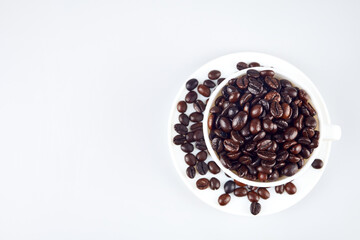 Coffee beans in the cup on white background.