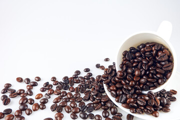 Coffee beans in coffee cup isolated on old wooden background,