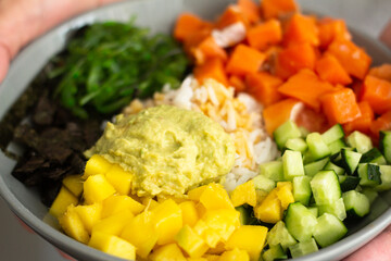 poke with salmon, seaweed and vegetables close-up.