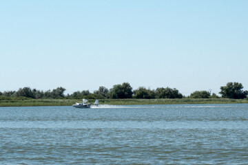 Small hydroplane landing on a lake in Danube Delta area, Dobrogea county, Romania, sunny summer day