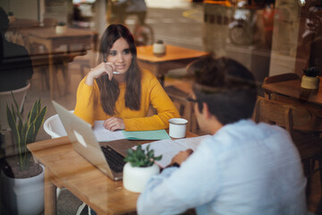 happy casual freelancers communicating in café discussing eco design connected to high speed 4g connection via laptop in coworking area