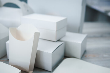 Different types of white cardboard packaging. For fast food, folding, large and small. The concept...