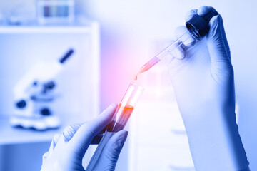 Scientist dripping sample into test tube, closeup. Laboratory analysis