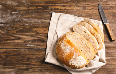 One bun of freshly baked bread. Homemade yeast-free pastries on a wooden rustic background. Flat layout copy space