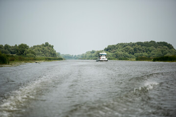 Boat on Danube river,  Danube delta area,  Romania,  in a sunny summer day