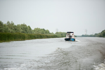 Boat on Danube river,  Danube delta area,  Romania,  in a sunny summer day