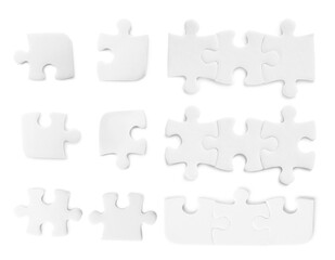 Naklejka premium Set with jigsaw puzzle pieces on white background, top view