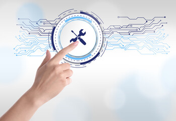 Woman touching icon on virtual screen against light background, closeup. Technical support