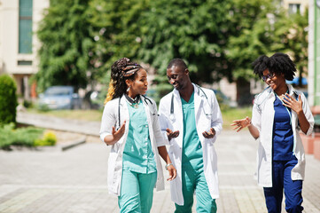 Three African American group doctors with stethoscope wearing lab coat.