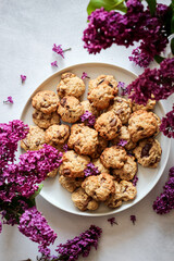 Chocolate chip cookies and purple lilac blooms shot from above