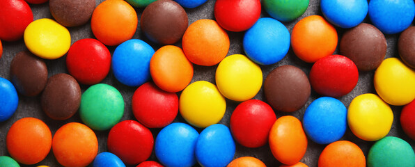 Fototapeta na wymiar Many colorful candies as background, top view. Banner design