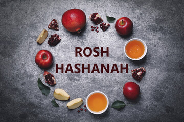 Naklejka na ściany i meble Frame of honey, apples and pomegranates on grey table, flat lay. Rosh Hashanah holiday
