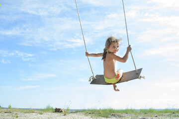 girl riding on a swing