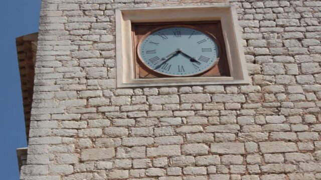 Big clock on a stone wall