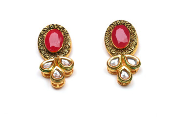 Beautiful Golden pair of earrings Diamonds gemstones on white background. Luxury female jewelry, Indian traditional jewellery, kundan earring,Bridal Gold earrings wedding jewellery