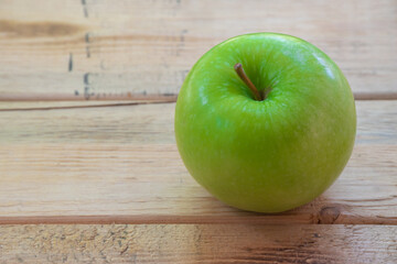 Green apple place on wooden table