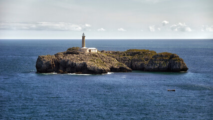 Beautiful lighthouse on an islet in the middle of the sea