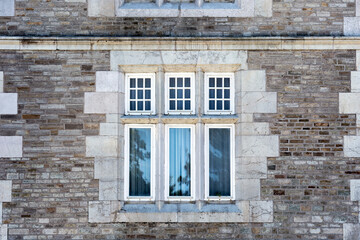 White windows in a stone facade