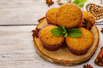Obraz na płótnie Canvas Homemade cupcakes with cinnamon, star anise and fresh mint. Autumn good mood, warm weather