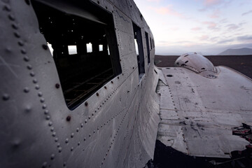 Abandoned and crashed military plane in a desert in Iceland. Window and wing detail.