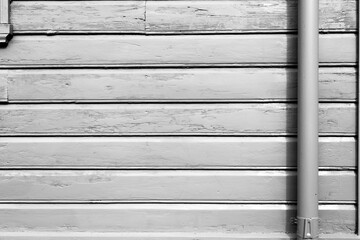 Silver colored wall with a vertical pipe