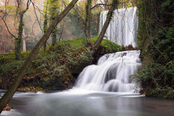 Two waterfalls in an autumnal forest