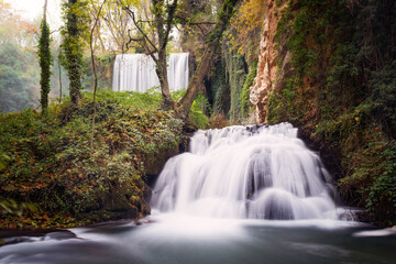 Two waterfalls in an autumnal forest