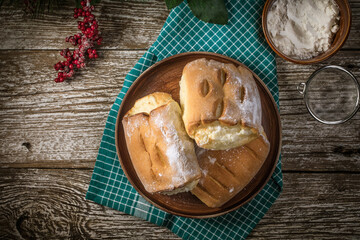 Sweet buns with cheese on wooden table.
