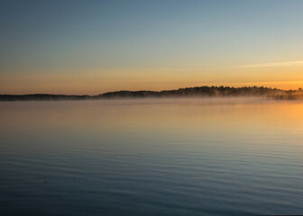 Foggy weather early in the morning on the lake. beautiful wallpapers. a mystical mist vibrates in the lake. summer sunrise